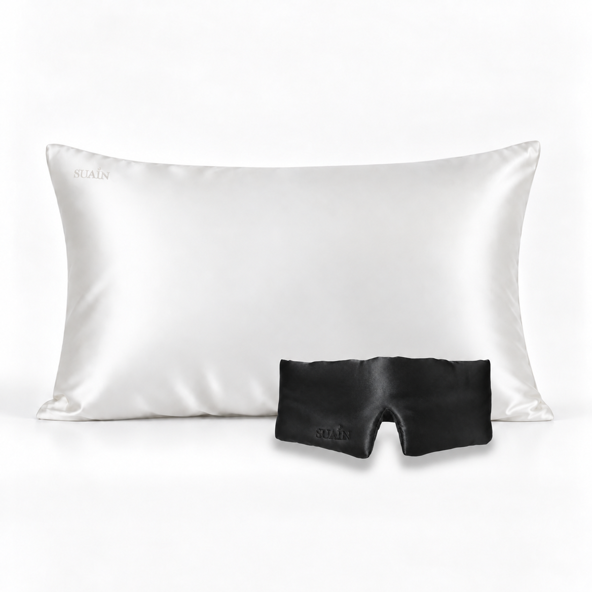 Ivory White silk pillowcase with a Midnight Black silk sleep mask