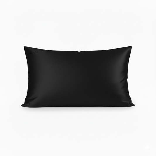 A black mulberry silk pillowcase with a subtle brand logo in the top left corner.